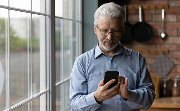 Middle aged man looking at his smartphone.