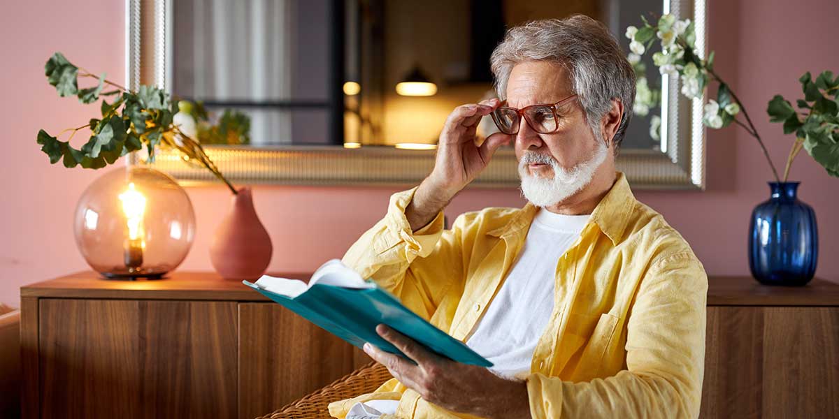Man reading book wearing bifocal glasses