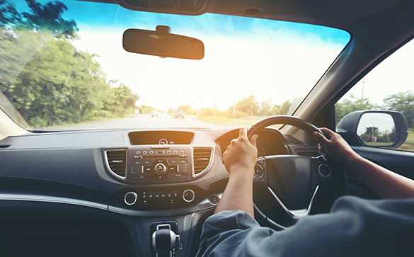 Picture of a person driving form seen from the backseat