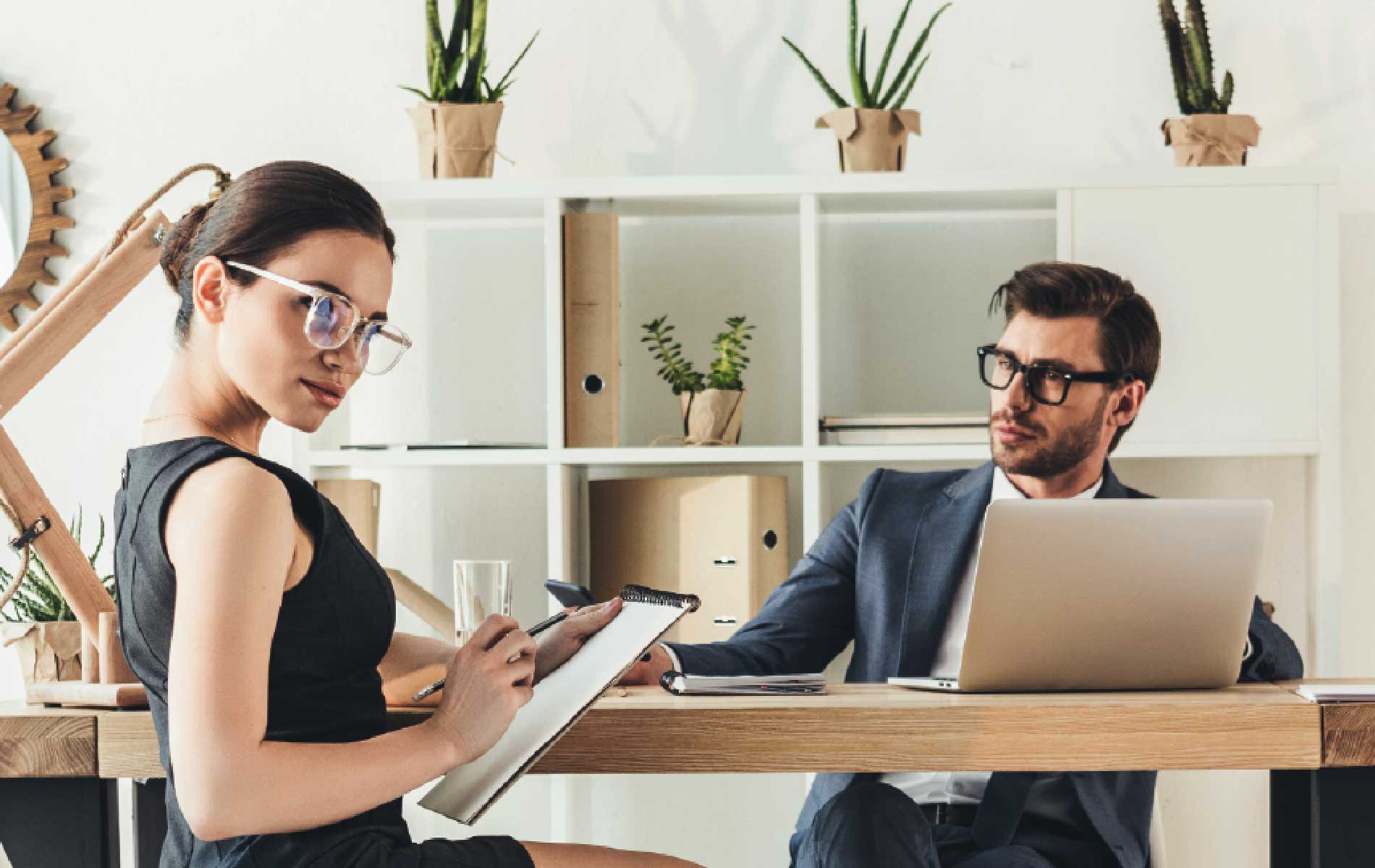 Man and woman in a office wearing glasses