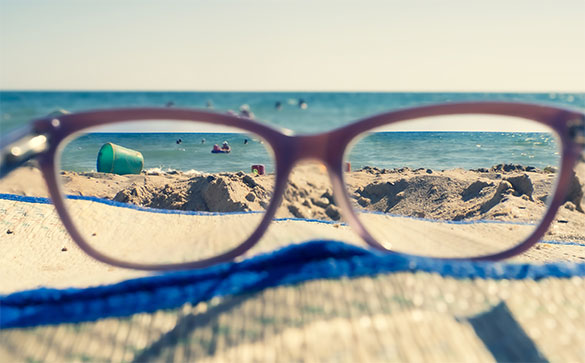 Glasses on a beach towel by the sea