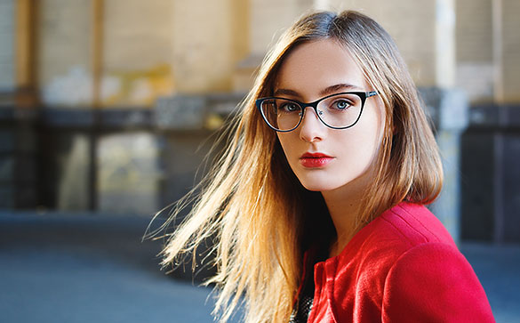 Blonde girl in a ref jacket wearing glasses