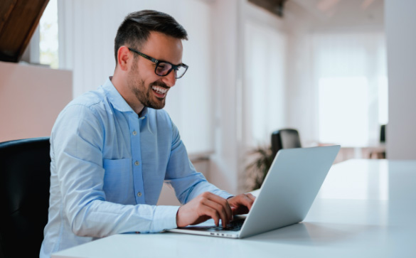 Man working on computer wearing glasses